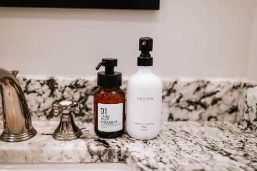 two bottles ofodorizers sitting on a bathroom sink at Stylish 2br Cabin C By Mhm Luxury Properties in Jasper
