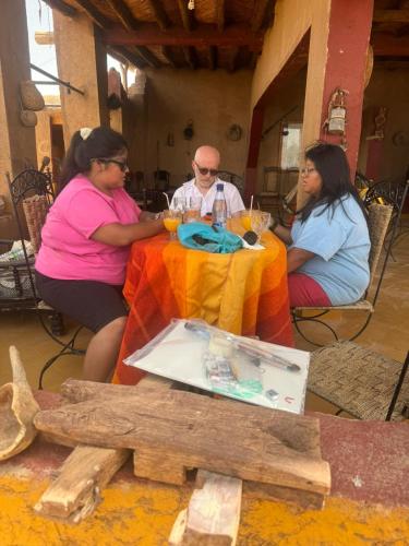a group of people sitting at a table with wine glasses at Dar dmana chez l'habitant in Skoura