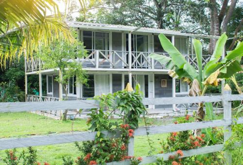 una casa blanca con una valla delante en Casa de Vacaciones ECOWASI VERAS, en Capurganá