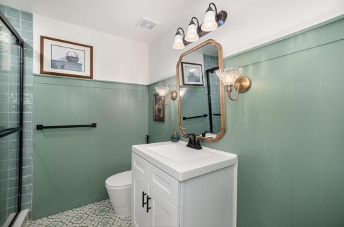 a bathroom with a sink and a mirror at Modern Bauhaus Condo with Pool in Indialantic