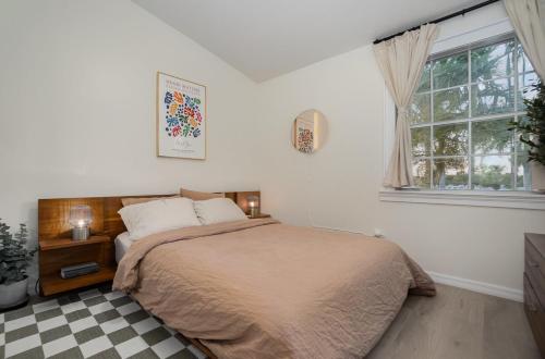 a bedroom with a bed and a window at Modern Bauhaus Condo with Pool in Indialantic