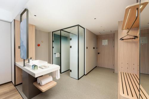 a bathroom with a sink and a mirror at Holiday Inn Express Jincheng New District by IHG in Jincheng