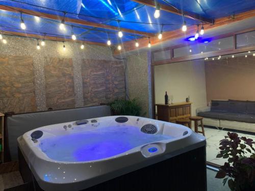 a large jacuzzi tub in a room with lights at Lejaim 