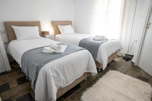 a bedroom with two beds with towels on them at Mountain Bell in Kalívia