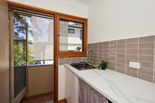 a kitchen with a sink and a window at 1B1B Private Studio near Doncaster Westfield in Doncaster
