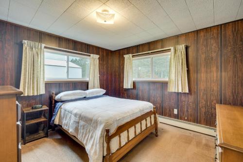 a bedroom with wood paneled walls and a bed at Fishers Retreat Hayward Home, Near ATV Trails! in Seeley