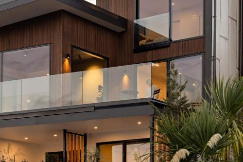 a house with large glass windows at Elevated Tranquility Luxe Lakeview Horizons in Queenstown