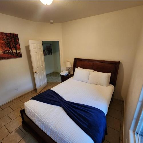a bedroom with a bed with a blue blanket on it at The Gathering Spot-6 miles from Sequoia Nlt'l Park in Three Rivers