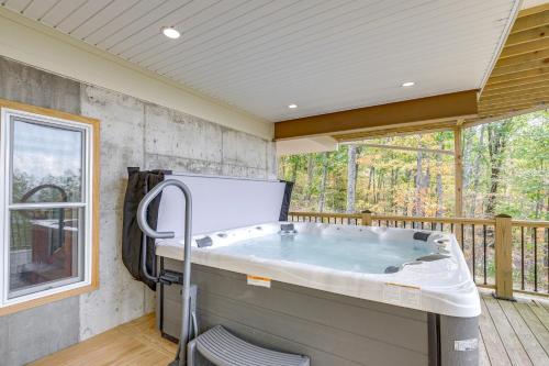 a jacuzzi tub in a room with a deck at Mtn Views and Spacious Deck! Modern Caldwell Getaway in Caldwell