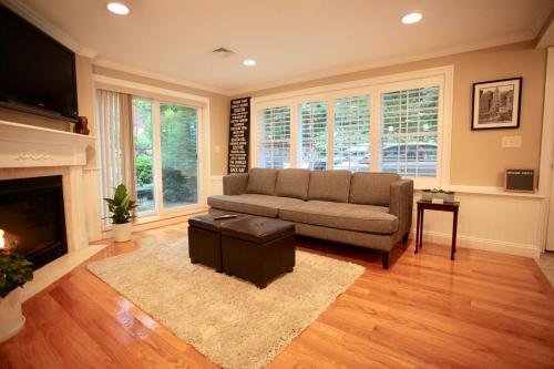 a living room with a couch and a fireplace at Peaceful 2BR near US Route 1 and Boston in Melrose