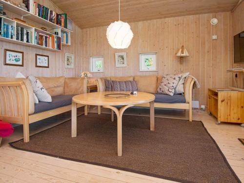 a living room with a couch and a table at Lakeview Hideaway - By Traum Ferienwohnungen in Ørby