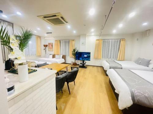 a living room with two beds and a dining room at 東田端2F-kKI0064 in Tokyo