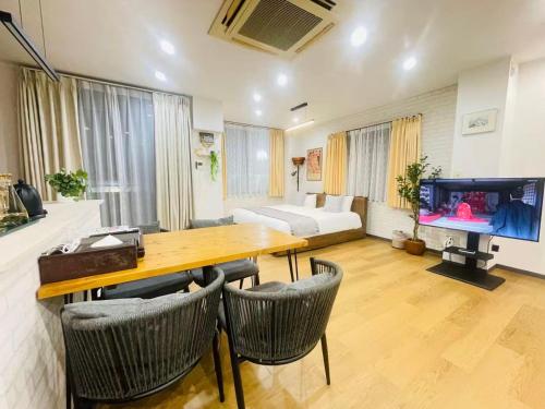 a living room with a table and a couch and a tv at 東田端2F-kKI0064 in Tokyo