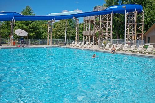 a person swimming in a large swimming pool at Fremont RV Campground Loft Cabin 4 in Fremont