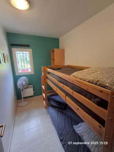 a bedroom with a bed and a window at Gites Villa Robinson in Mazamet