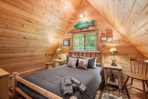 a bedroom with a bed in a log cabin at Antler House in Ashford