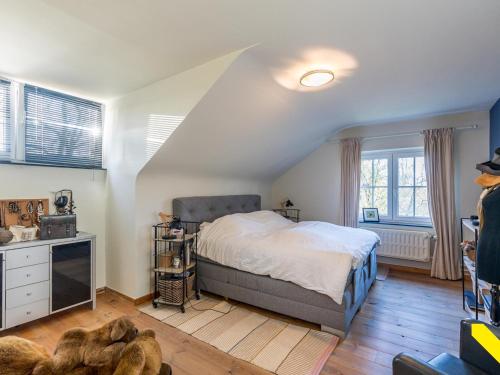 a bedroom with a bed in a attic at Wezelhoeve in Balen