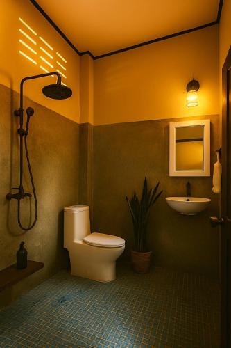 a bathroom with a toilet and a sink at Starlight Bungalows - 3 Mins Walk To Beach in Ko Lanta Yai