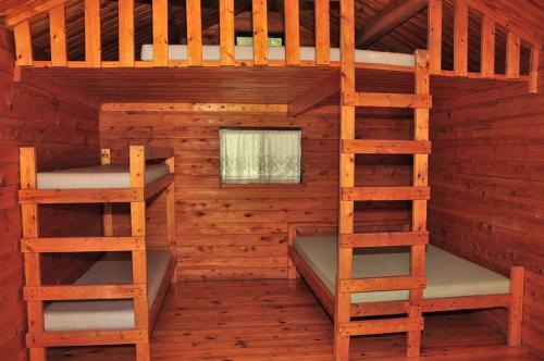 a bedroom with two bunk beds in a wooden cabin at Fremont RV Campground Loft Cabin 1 in Fremont