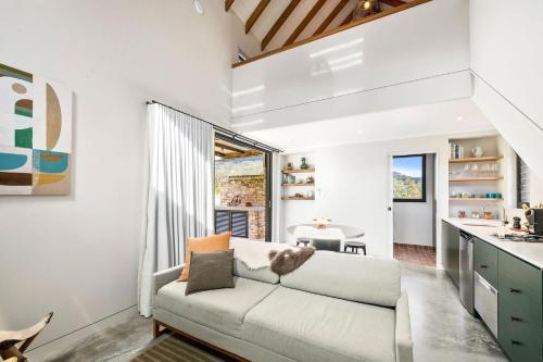 a living room with a couch and a table at Nido, Kangaroo Valley in Upper Kangaroo River