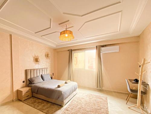 a bedroom with a bed and a chandelier at Endless Wave Retreat in Agadir