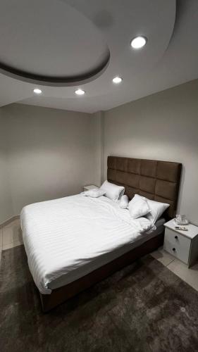 a bedroom with a large bed with white sheets at Apartment, room, elegant and comfortable hall, and smart entrance in Al Madinah