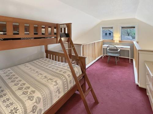 a small bedroom with a bunk bed and a desk at Woods Village 43 in Killington