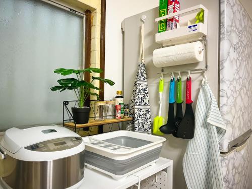 a kitchen with a mixer and utensils at Kanchi Guesthouse in Osaka