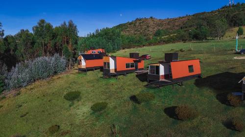 an overhead view of a group of houses on a hill at Costa Azul Refugio Frailejon in Tibasosa