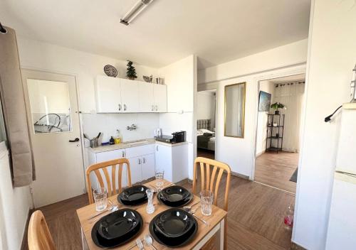 a kitchen and dining room with a table and chairs at Seaside Vacation in Haifa