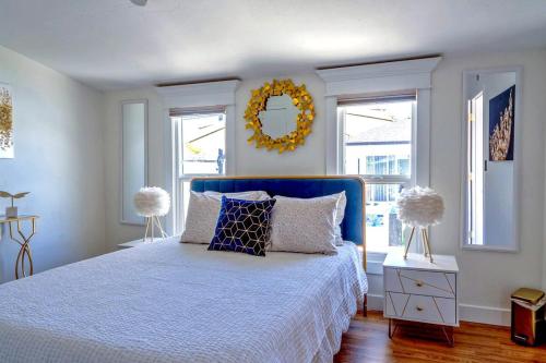 a bedroom with a blue bed and a mirror at Casa Lumina in Phoenix