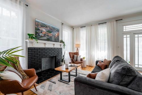 a living room with a couch and a fireplace at Newly Reno'd Historic Mansion 1 Mile to UF & DT in Gainesville