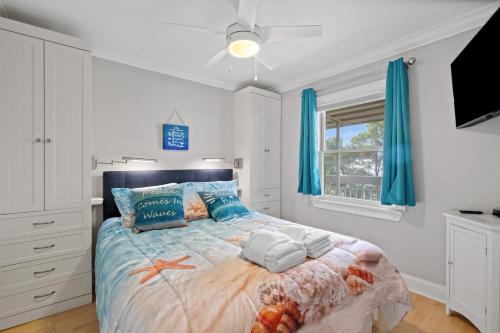 a bedroom with a large bed with blue curtains at 328 Breakers Oceanfront Hilton Head Condo Amazing Ocean Beach View Heated Pool & Family-Friendly in Hilton Head Island