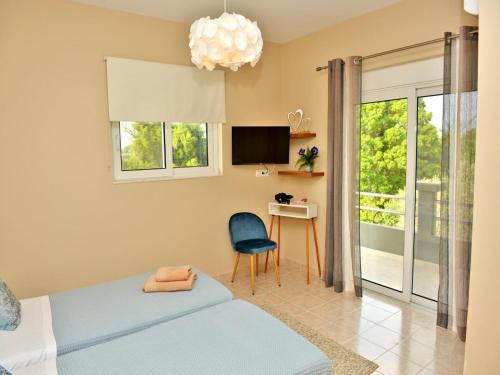 a bedroom with a bed and a desk and a tv at Elegant Villa with Pool & Garden in Eleousis in Kalithies
