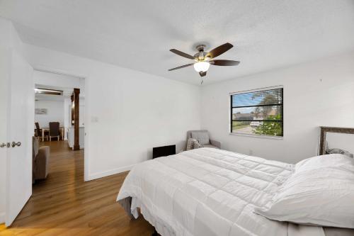 a bedroom with a bed with a ceiling fan at Your Perfect Port Charlotte Retreat in Murdock