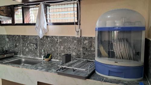 a kitchen with a food processor on a counter at Charity Pension House in San Vicente