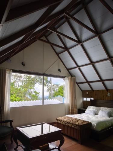 a bedroom with a bed and a large window at Chalet Gardel in San Francisco