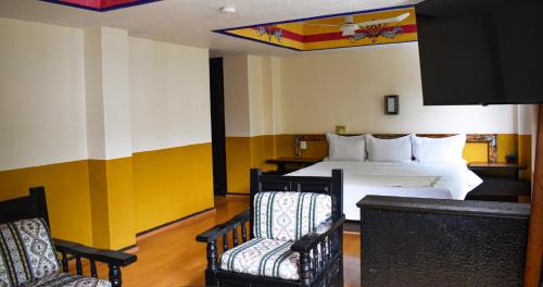 Tempat tidur dalam kamar di Hotel Benedicta