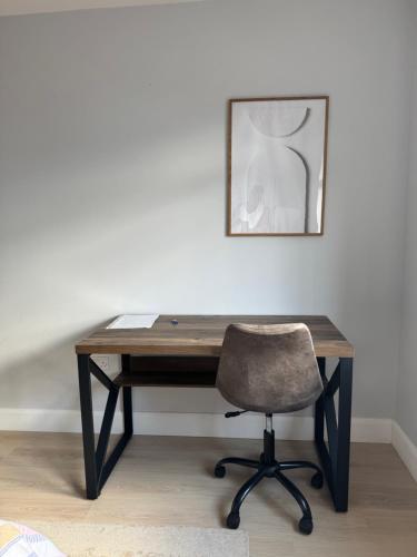 a desk with a chair and a picture on the wall at Large bedroom near to the center in Cork