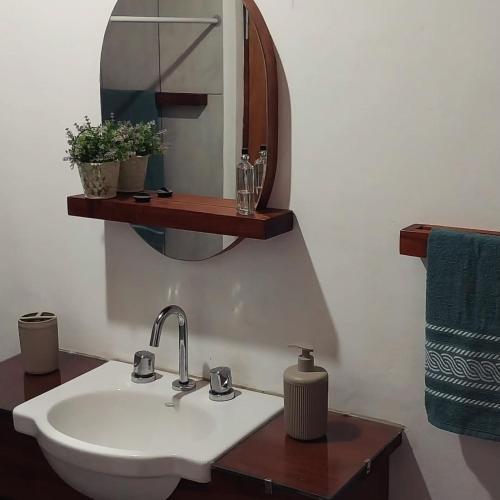 a bathroom with a white sink and a mirror at Serendipia in Oberá