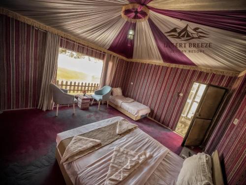 a bedroom with a tent brigade sign on the ceiling at RUM DESERT BREEZE lUXURY CAMP in Wadi Rum