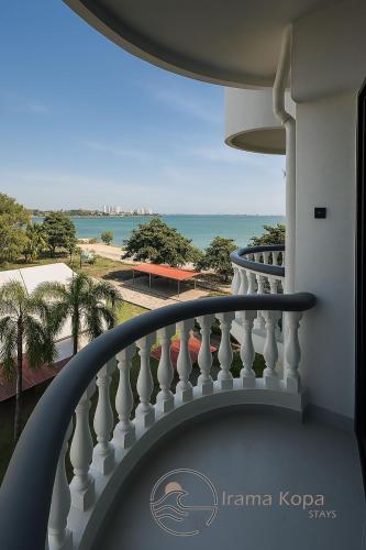 a balcony with a view of the ocean at Irama Kopa - Glory Beach Resort in Port Dickson
