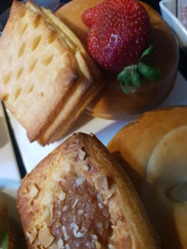a plate of food with waffles and a strawberry at Plateau Lodge in National Park