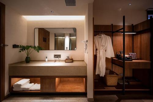 a bathroom with a sink and a mirror at 大有观于All about Yu Hotel in Chongqing