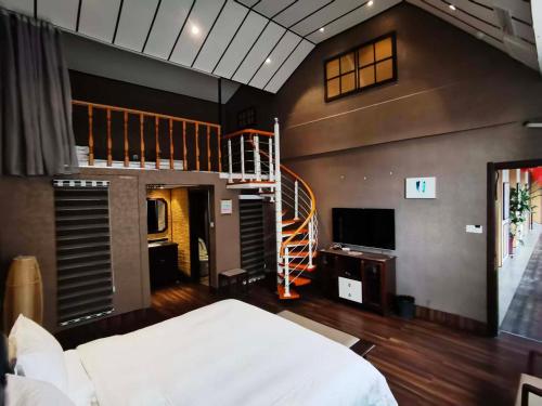 a bedroom with a bed and a spiral staircase at Zhifang Hotel in Datong