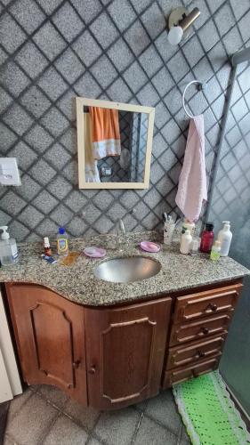 eine Badezimmerablage mit Waschbecken und Spiegel in der Unterkunft Casa Marcia in Belém