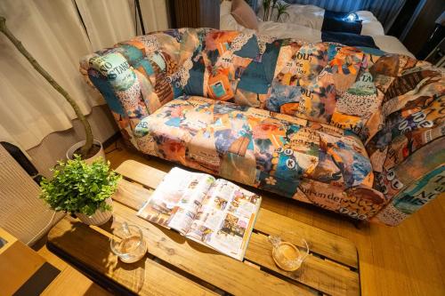 a living room with a couch and a wooden table at MOMOYA nagomi in Okayama