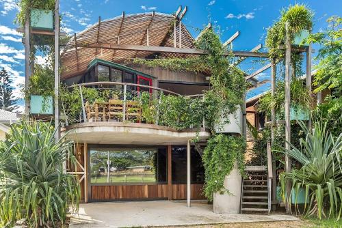 a house with a round roof with plants on it at South Beach House - 8 South Beach Lane in Brunswick Heads