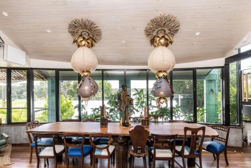 a dining room with a wooden table and chairs at South Beach House - 8 South Beach Lane in Brunswick Heads