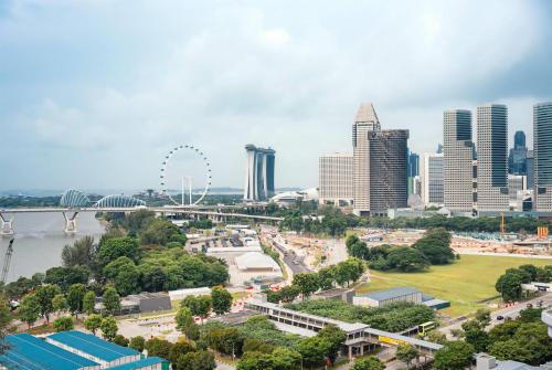 a view of a city skyline with a ferris wheel at Hotel Traveltine Downtown Singapore, Trademark Collection in Singapore